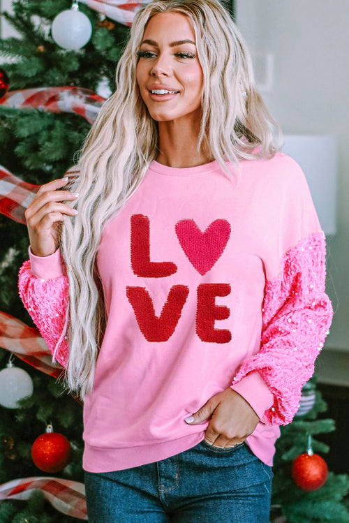 Pink Valentines LOVE chenille embroidered sequin sleeve sweatshirt from Harlequin Daisy, featuring soft fabric and decorative embellishments.