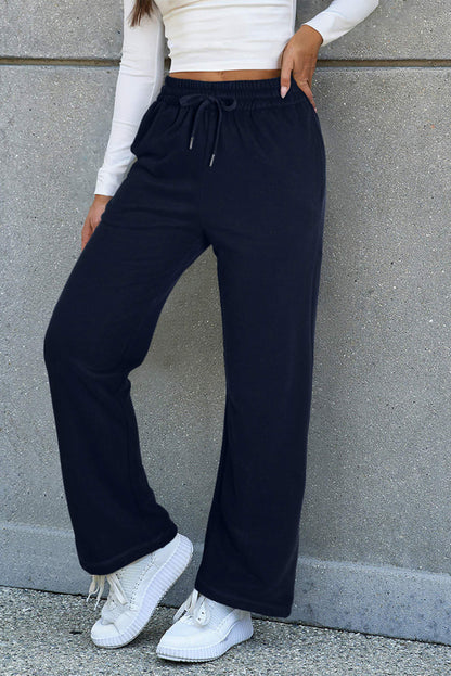 Navy blue fleece-lined casual pants with drawstring waist by Carmine Juneberry, cozy and comfortable for everyday wear.