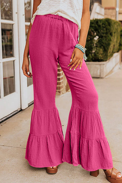 Rose textured high waist ruffled bell bottom pants by Carmine Juneberry, showing the detailed fabric and stylish flare design.