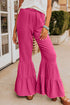 Rose textured high waist ruffled bell bottom pants by Carmine Juneberry, showing the detailed fabric and stylish flare design.