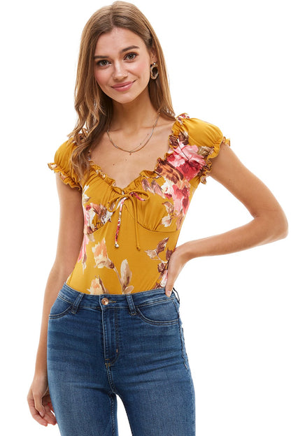 Floral printed peasant style bodysuit for women by Indigo Arrowwood, featuring a relaxed fit and floral pattern.