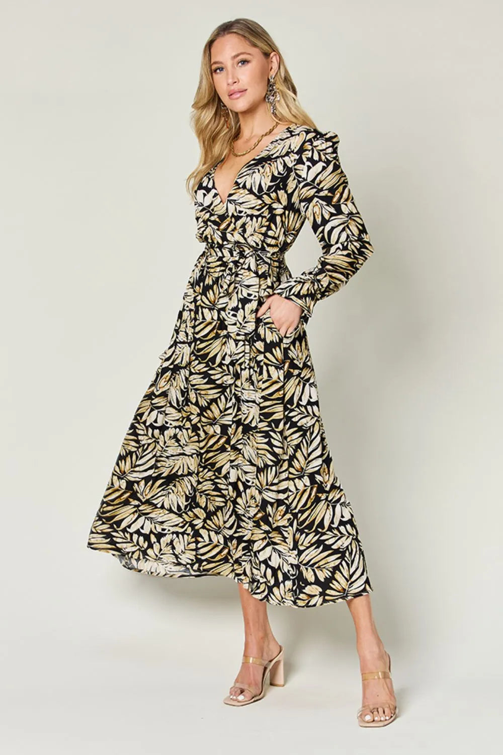 Pear Daisy Double Take full size tie-back flounce sleeve dress displayed on a hanger, featuring a stylish, flowy design.