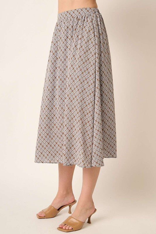Printed midi skirt by Mittoshop in the automotive pattern, featuring a flowy design and vibrant print, styled on a mannequin.