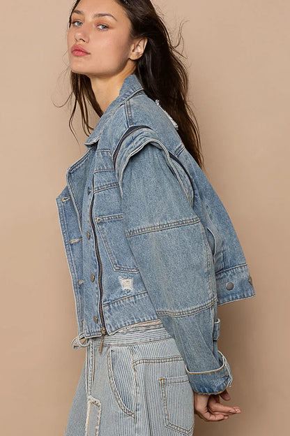 Pear Daisy POL cropped denim jacket with functional zipper detail, shown in a stylish home and garden setting.