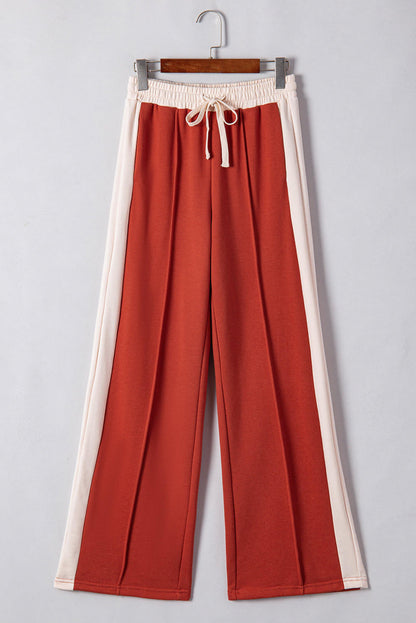 Carmine Juneberry flamingo color block drawstring high waist wide-leg pants displayed on a hanger.