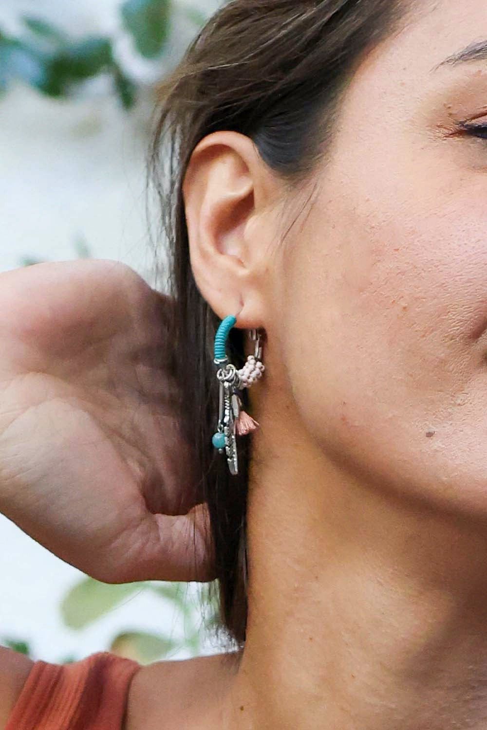 Dainty feather hoop earrings by Periwinkle Aether featuring fringed feather design, perfect for stylish accessories.