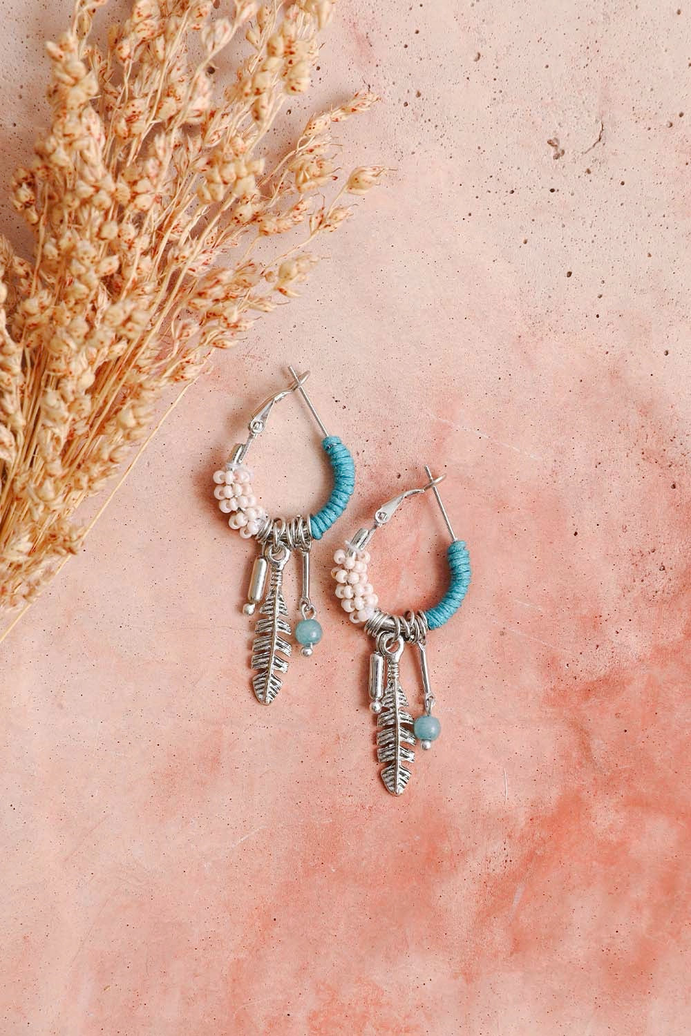 Dainty feather hoop earrings by Periwinkle Aether with delicate fringe design, perfect as stylish accessories.