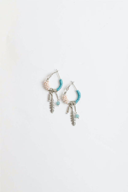 Dainty feather hoop earrings by Periwinkle Aether with delicate feather fringe, stylish accessories for a subtle, elegant look.