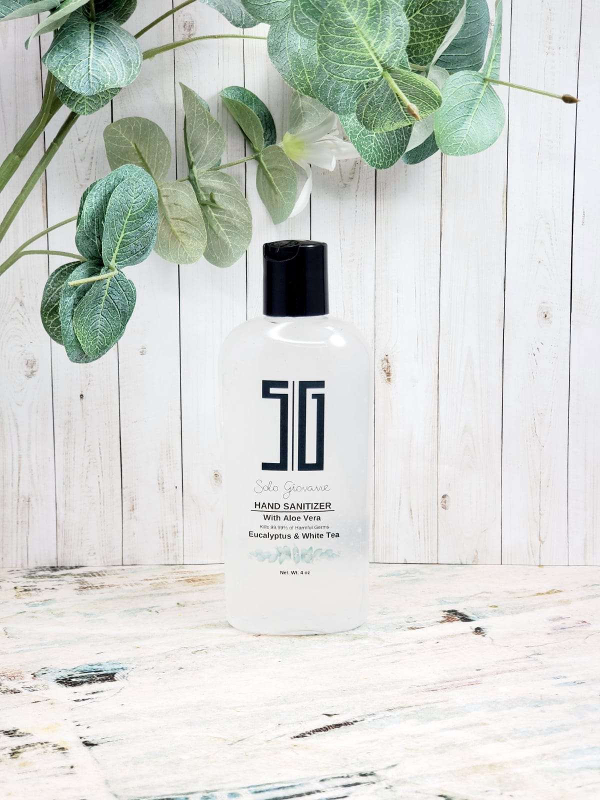 Sky Blue Lucy eucalyptus and white tea hand sanitizer bottle with pump, in a bathroom setting, emphasizing natural ingredients and clean design.
