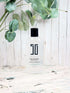 Sky Blue Lucy eucalyptus and white tea hand sanitizer bottle with pump, in a bathroom setting, emphasizing natural ingredients and clean design.
