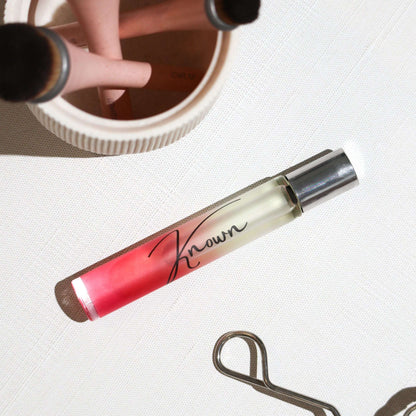 Plum Beech Known Rollerball Perfume in a sleek glass bottle, designed for easy application and portable fragrance.