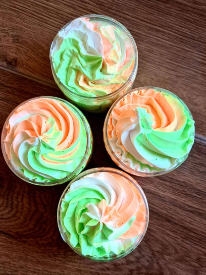 Amethyst Meleager Coco Mango Shower Fluff whipped soap in a 6-unit case, showing fluffy, creamy bath and beauty product.