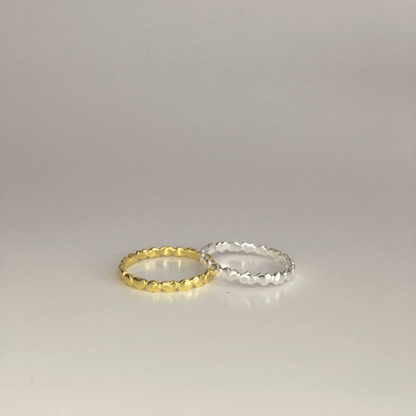 Cerise Poppy Circle of Love ring featuring a delicate gold band and a heart-shaped charm, elegant jewelry for special occasions.