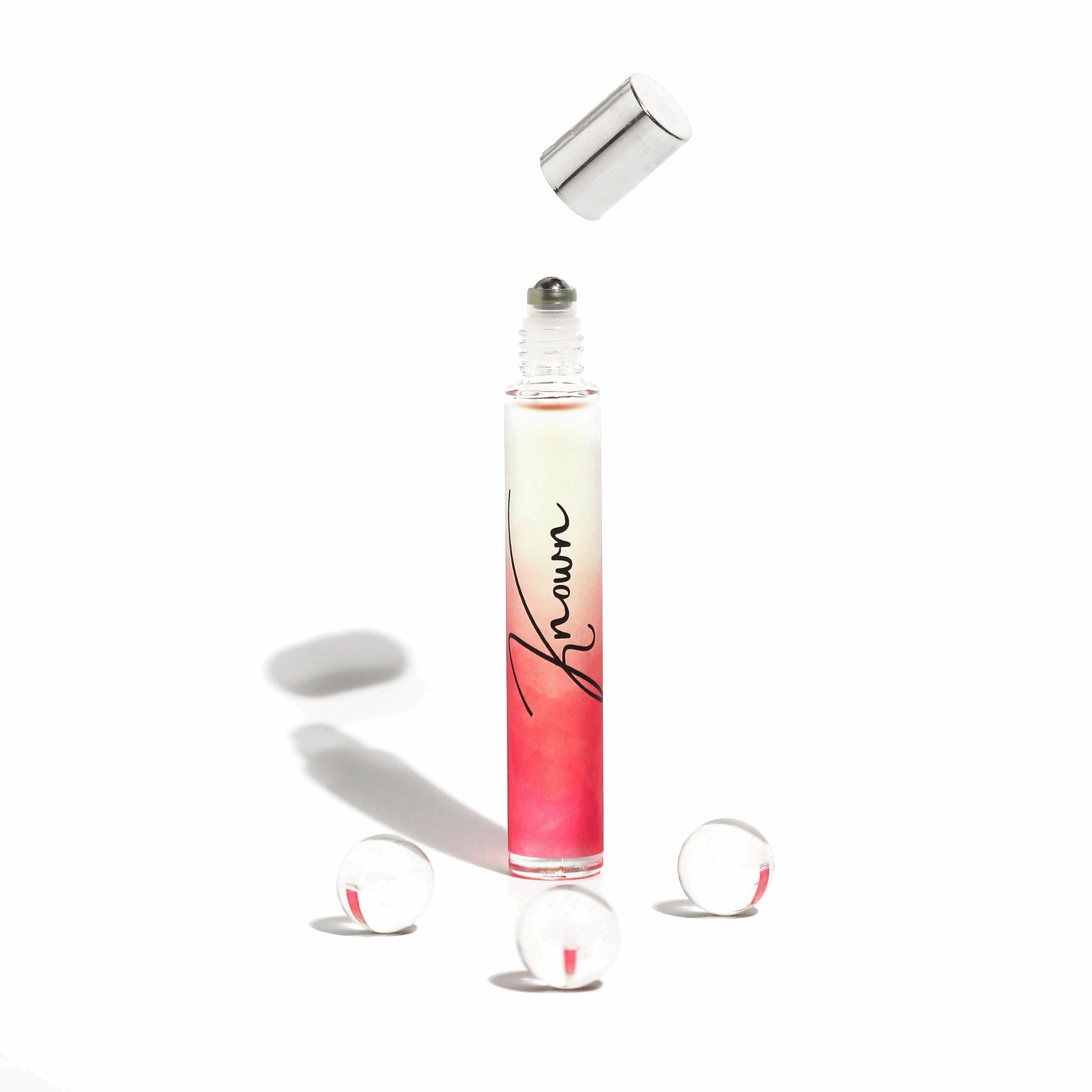 Plum Beech Known rollerball perfume in a sleek glass bottle, designed for easy application and portable fragrance.