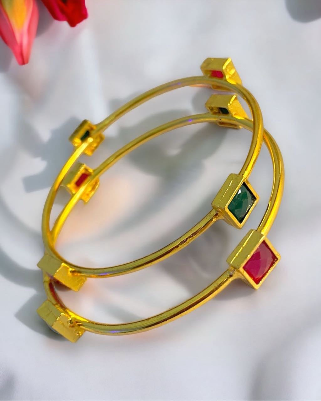 Gold-plated Indian bangle jewelry from Gray Poseidon featuring traditional and modern design elements.