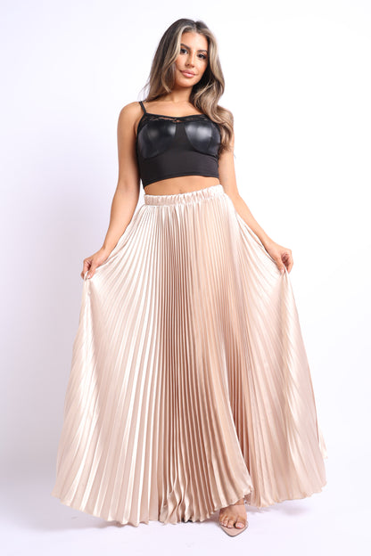 Taupe satin maxi skirt with elastic high waist and pleated A-line design by Puce Juniper, shown on a model.