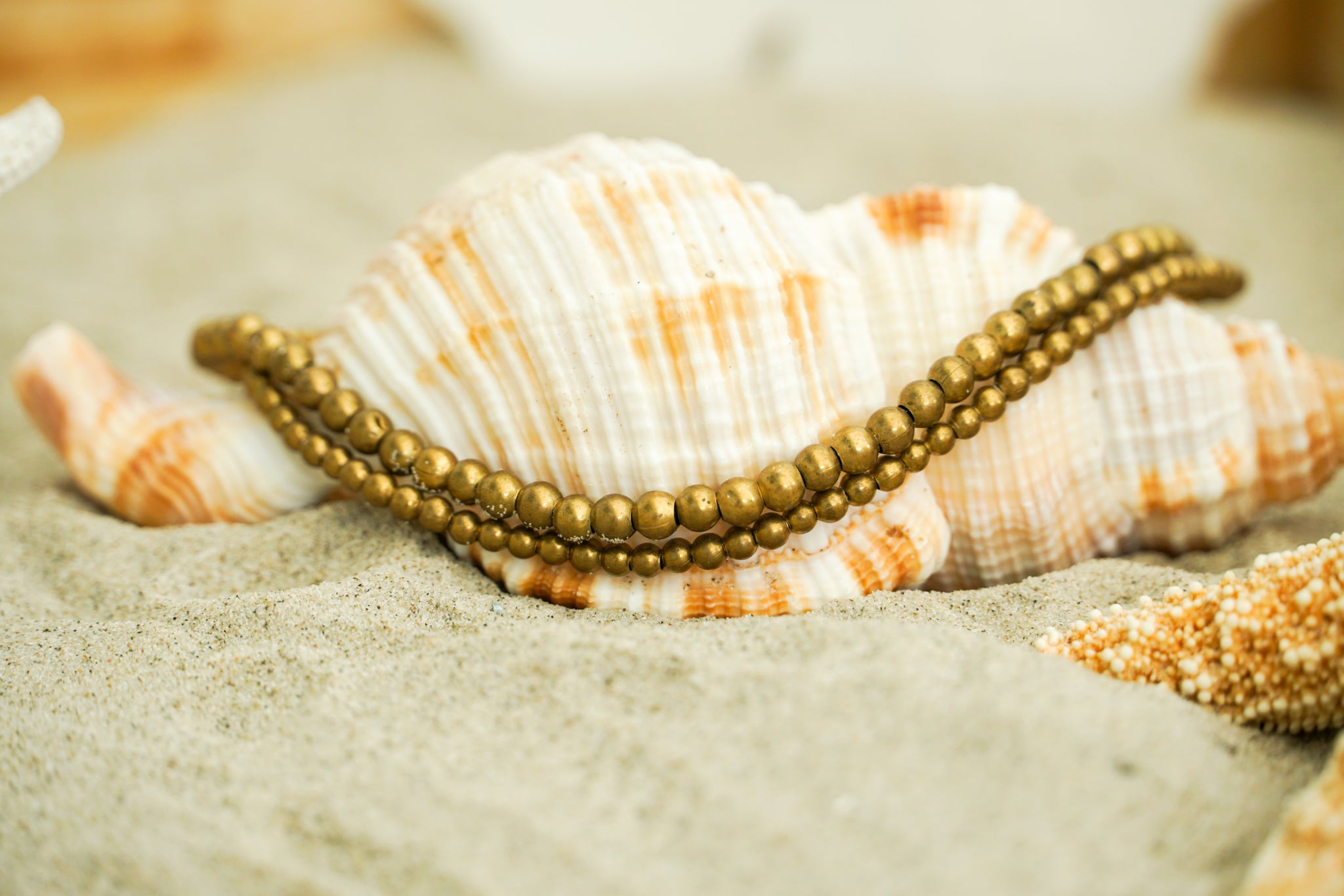 Golden double strand brass boho bracelet with hippie style, featuring layered design and intricate details by Tan Smokey.