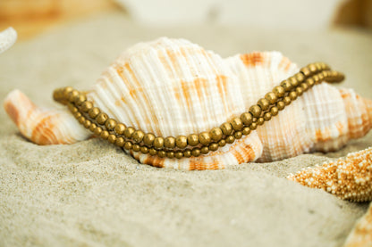 Golden double strand brass boho bracelet with hippie style, featuring layered design and intricate details by Tan Smokey.