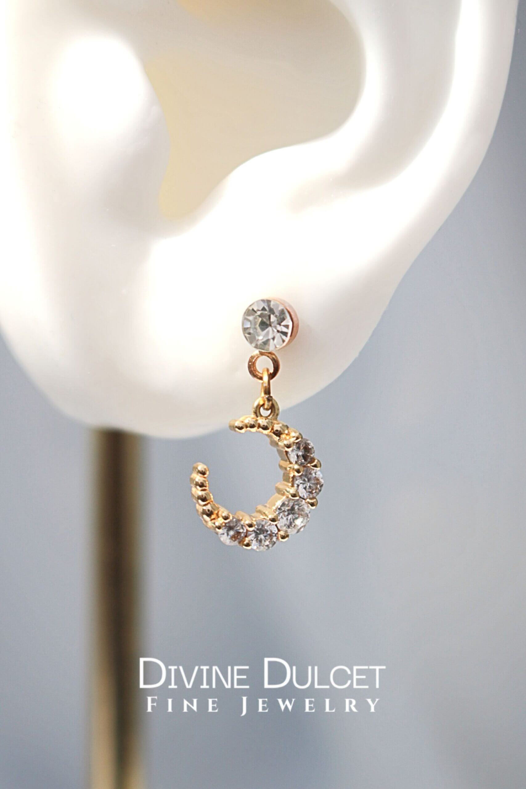 Ultramarine Birch 24 Karat Moon Cubic Zirconia Stud Earrings featuring luminous moon-shaped gemstones on silver studs.