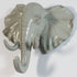 Resin elephant head hook from Fuchsia Molly, mounted on a wall, used for hanging items in home and garden decor.