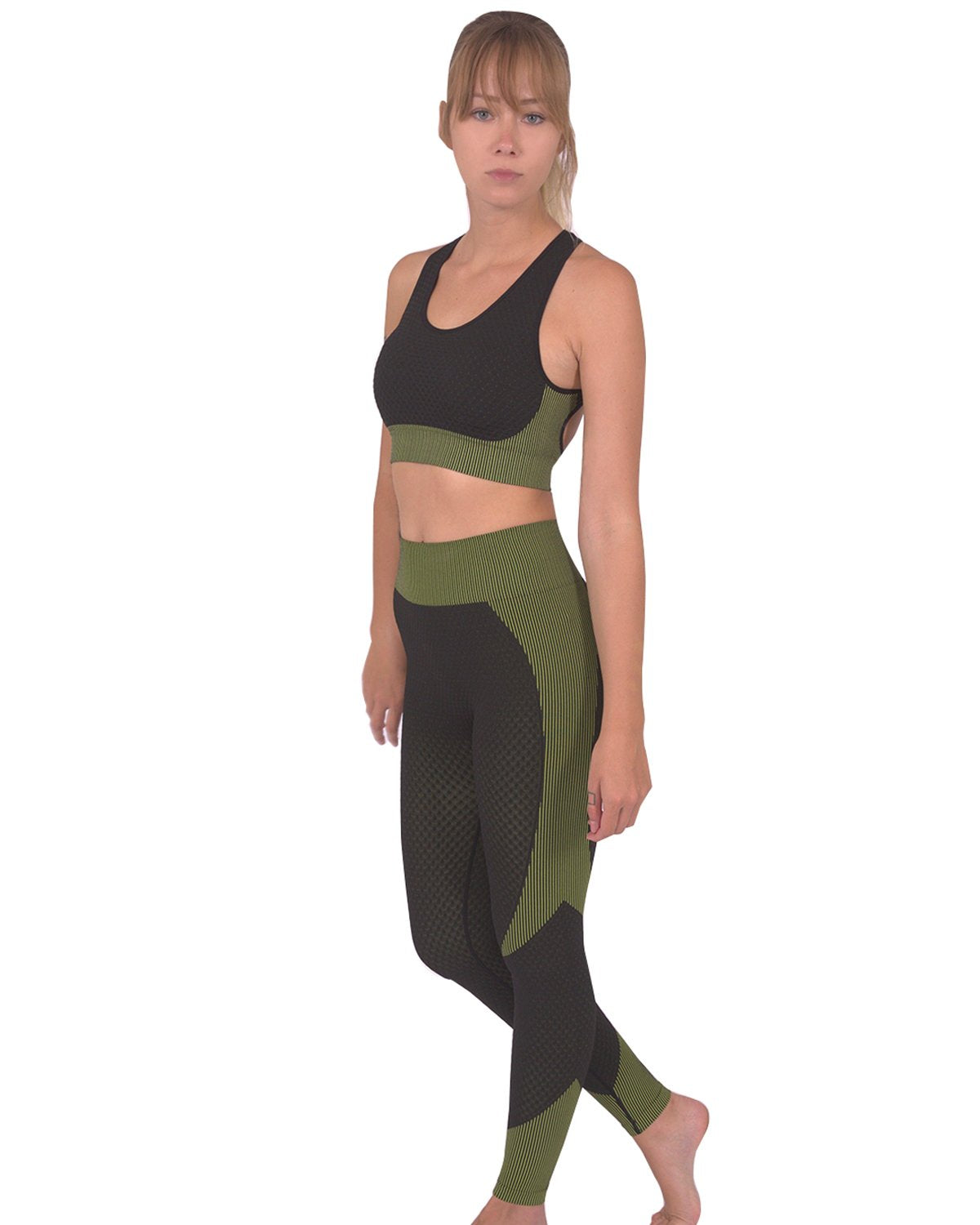 Lazurite Trois Seamless Leggings in black with green accents, activewear leggings with a seamless design, shown on a model.
