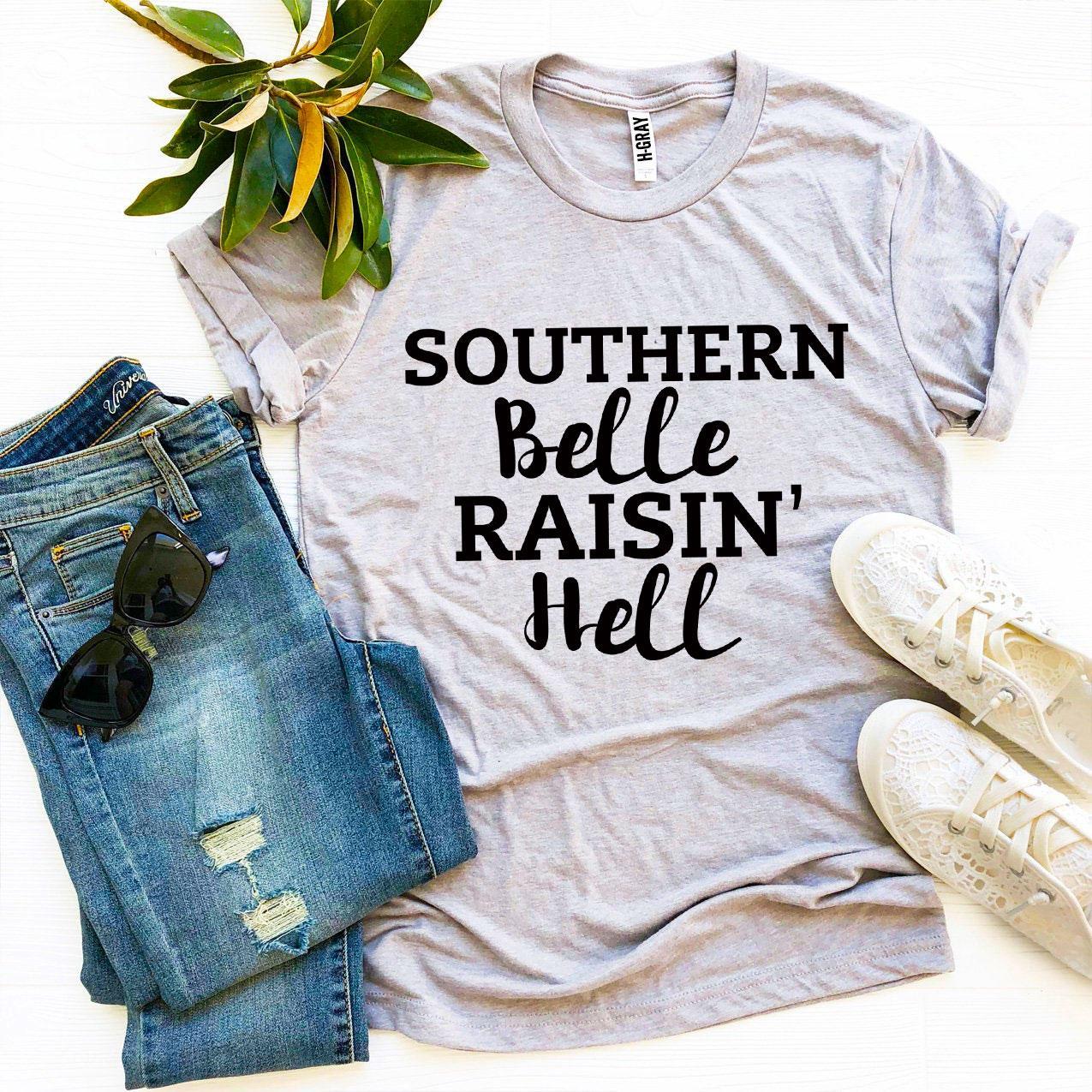 Red Southern Belle Raisin’ Hell T-shirt by Agate featuring bold graphic design and comfortable cotton fabric.