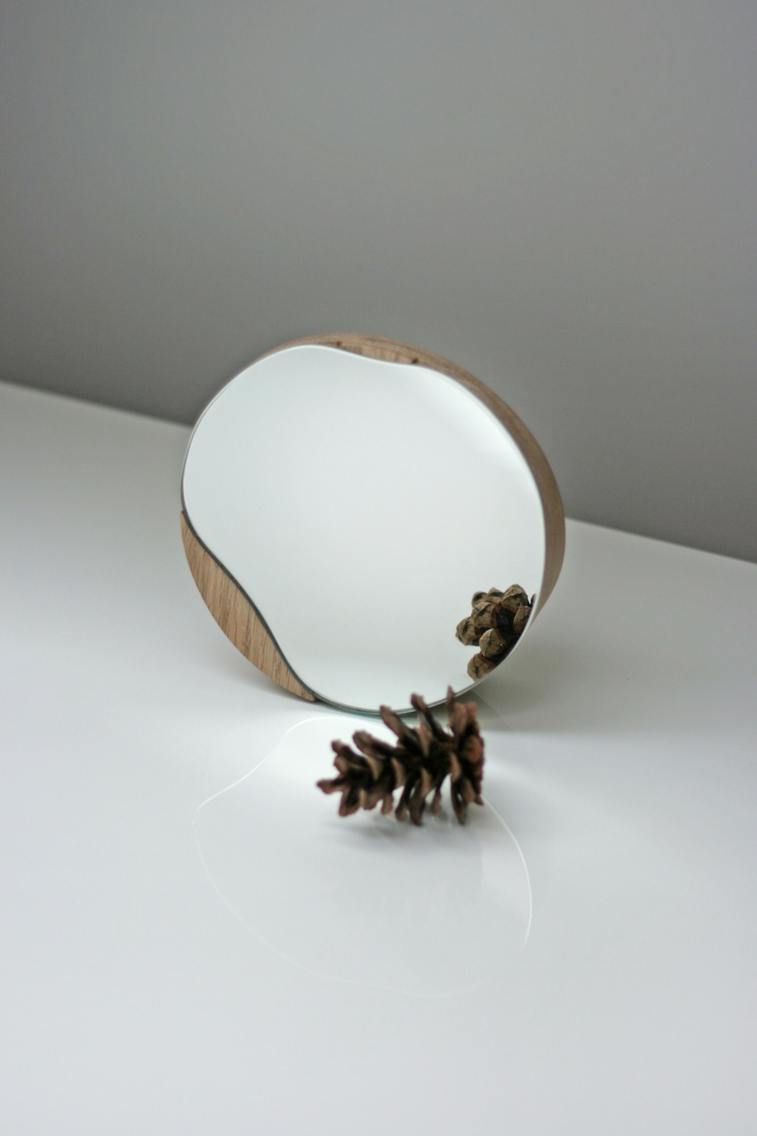 Biotite bathroom cosmetic round mirror with oak wood or black frame, designed for elegant bathroom decor.
