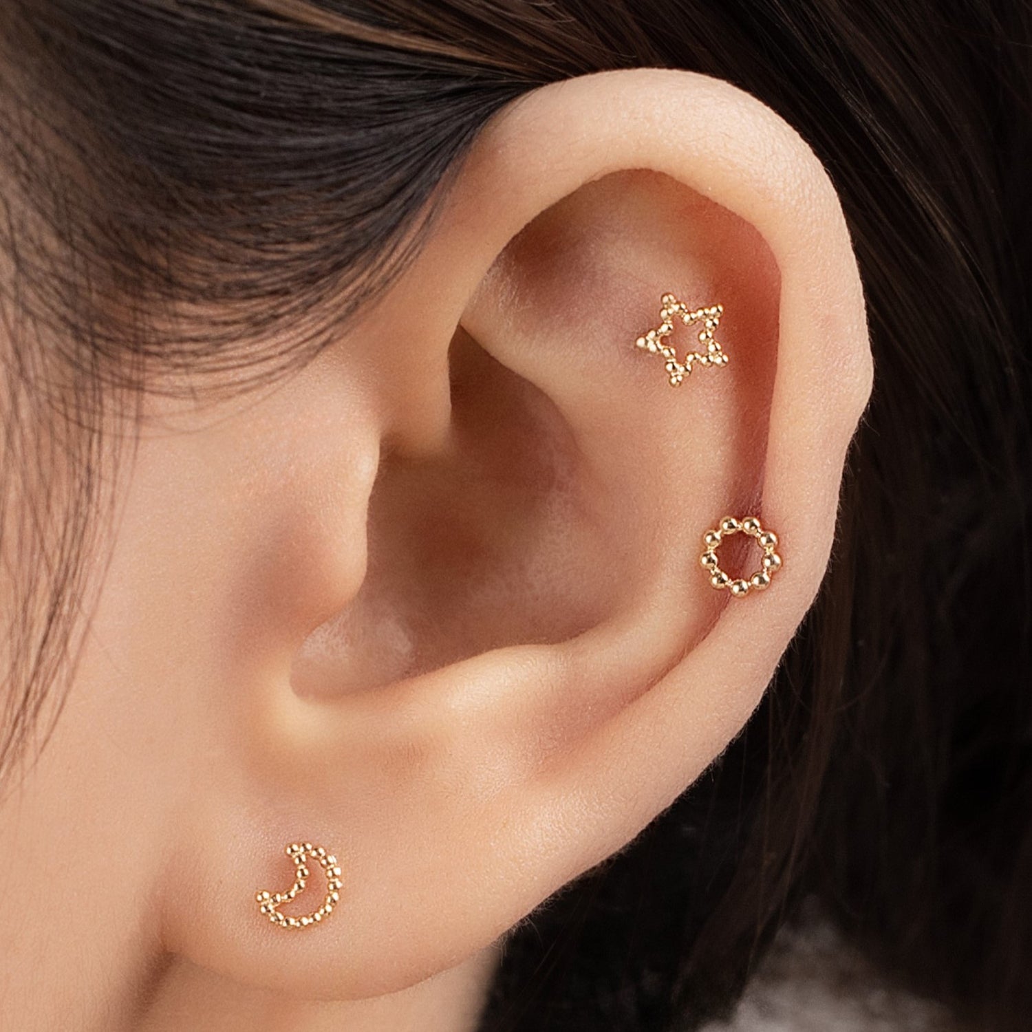 Blue Chrysippus 14K solid gold Stella piercing earrings featuring a star-shaped design with a polished finish.