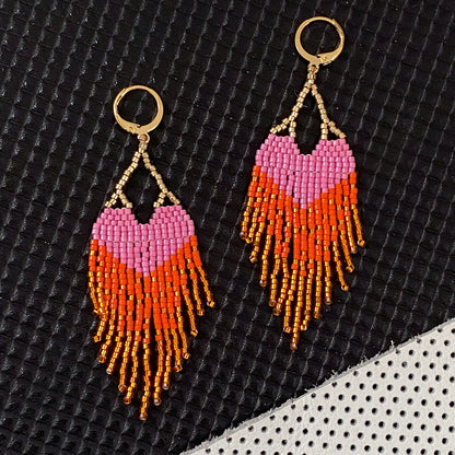 Yellow Athena LOVE earrings featuring pink and orange ombre fringe, with long, dangling earring design and colorful tassel accents.