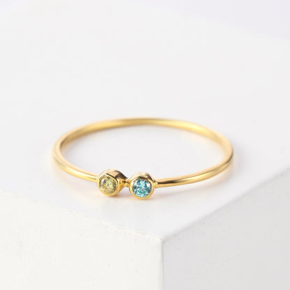 Green Millie mom birthstone ring featuring children’s birthstones, crafted in silver with colorful gemstone accents.