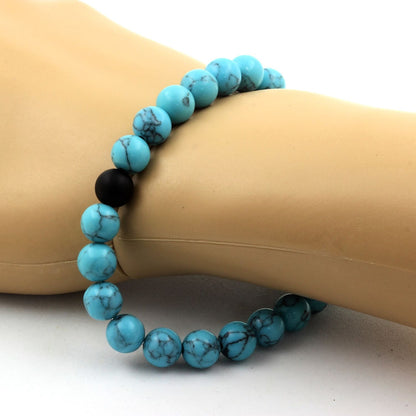 Turquoise and matte black onyx bracelet with 8mm beads from Tan Coconut featuring vibrant turquoise and sleek black stones.