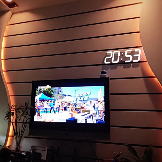 Fuchsia Molly digital LED wall clock displaying time in a sleek, modern design for audio and video room decor.