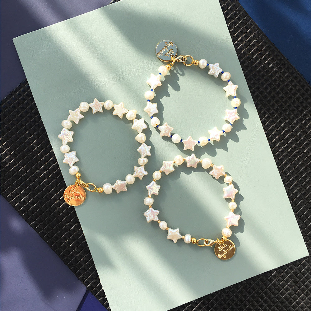 Yellow Athena Pearl Stars bracelet featuring white pearls and star-shaped charms on a delicate bracelet band.