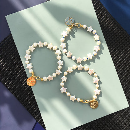 Yellow Athena Pearl Stars bracelet featuring white pearls and star-shaped charms on a delicate bracelet band.