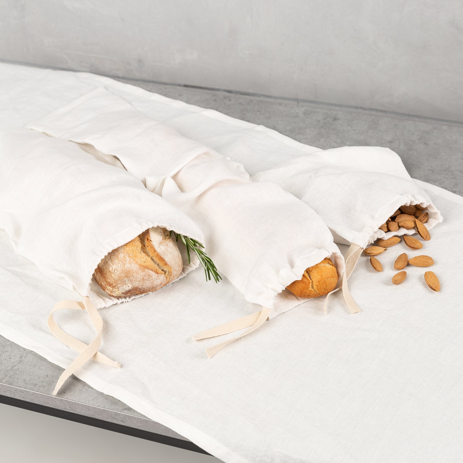 Off-white linen bread bag by Biotite, kitchen storage accessory with a soft, natural fabric design for fresh bread preservation.