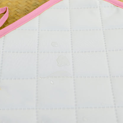 Pink Nomadic Changing Mat for kids and babies by Chocolate Briseis, featuring a soft, portable design with colorful patterns.
