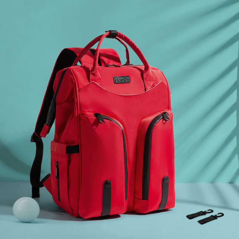 Carmine Juneberry SmartMom Travel+ Diaper Backpack with multiple compartments, ergonomic straps, and stylish design for moms on the go.