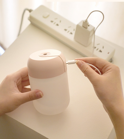 Mini portable ultrasonic air humidifier and aroma diffuser by Lilac Milo, compact tech accessory for adding moisture and scent.