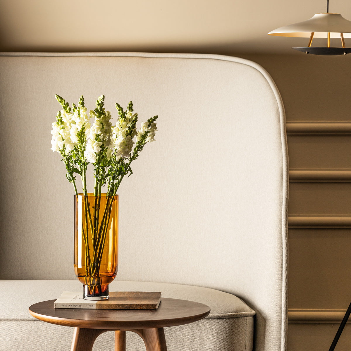 Sober modern glass vase by Harlequin Poplar with cylindrical shape and solid base, in warm dark color, ideal for home decor.