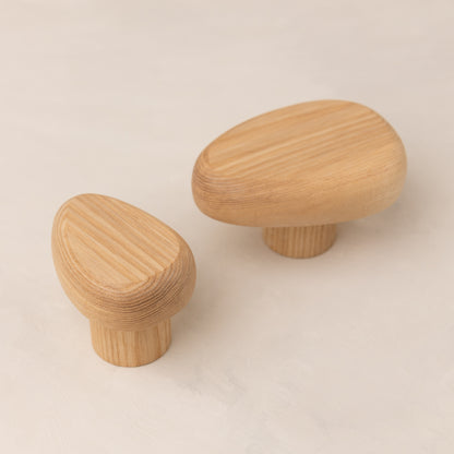 Wooden wall hook DROP by Biotite, used for organization, mounted on wall with a natural wood finish for hanging items.