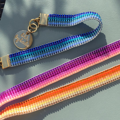 Yellow Athena Skinny Ombre Bracelet featuring blue, pink, and orange gradient colors on a sleek, stylish bracelet design.