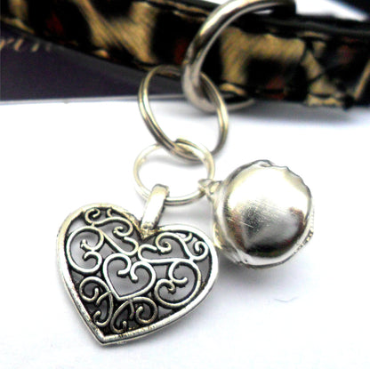 Salmon Oscar filigree heart pet charm attached to a collar, designed for leashes, collars, and petwear, with intricate metalwork.