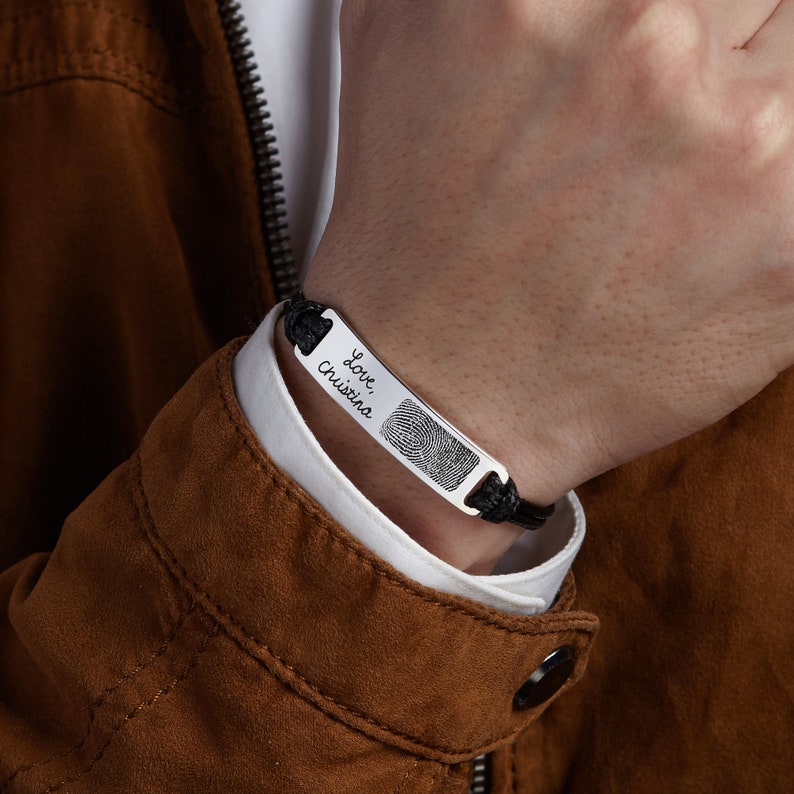 Green Millie fingerprint handwriting bracelet for men, close-up of stainless steel bracelet with engraved fingerprint and handwritten design.