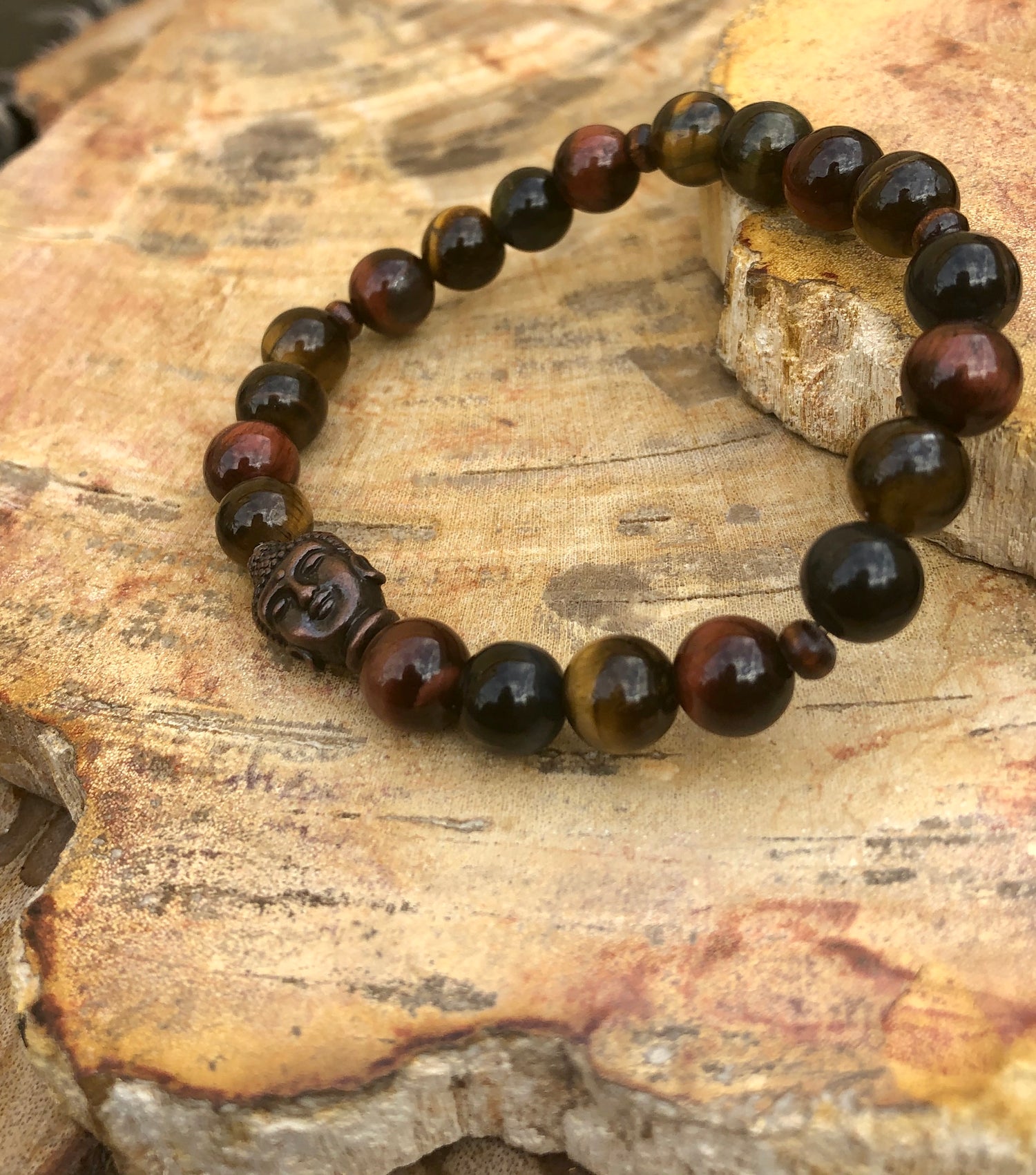 Violet Chaos tiger eye and Buddha gemstone stretch bracelet with polished beads and intricate Buddha charm.