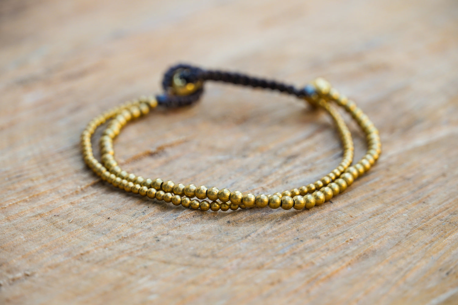 Golden double strand boho brass bracelet by Tan Smokey featuring hippie-inspired design and intricate detailing.