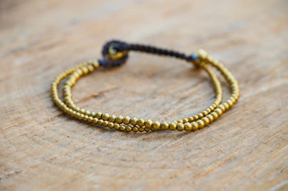 Golden double strand boho brass bracelet by Tan Smokey featuring hippie-inspired design and intricate detailing.