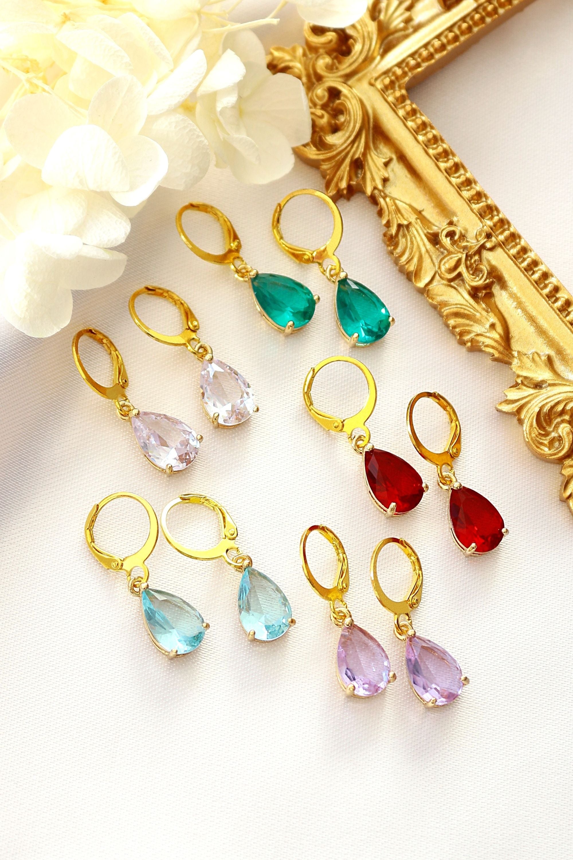Ultramarine Birch 18K rainbow teardrop hoop earrings featuring colorful, shiny gold earrings with a teardrop design.