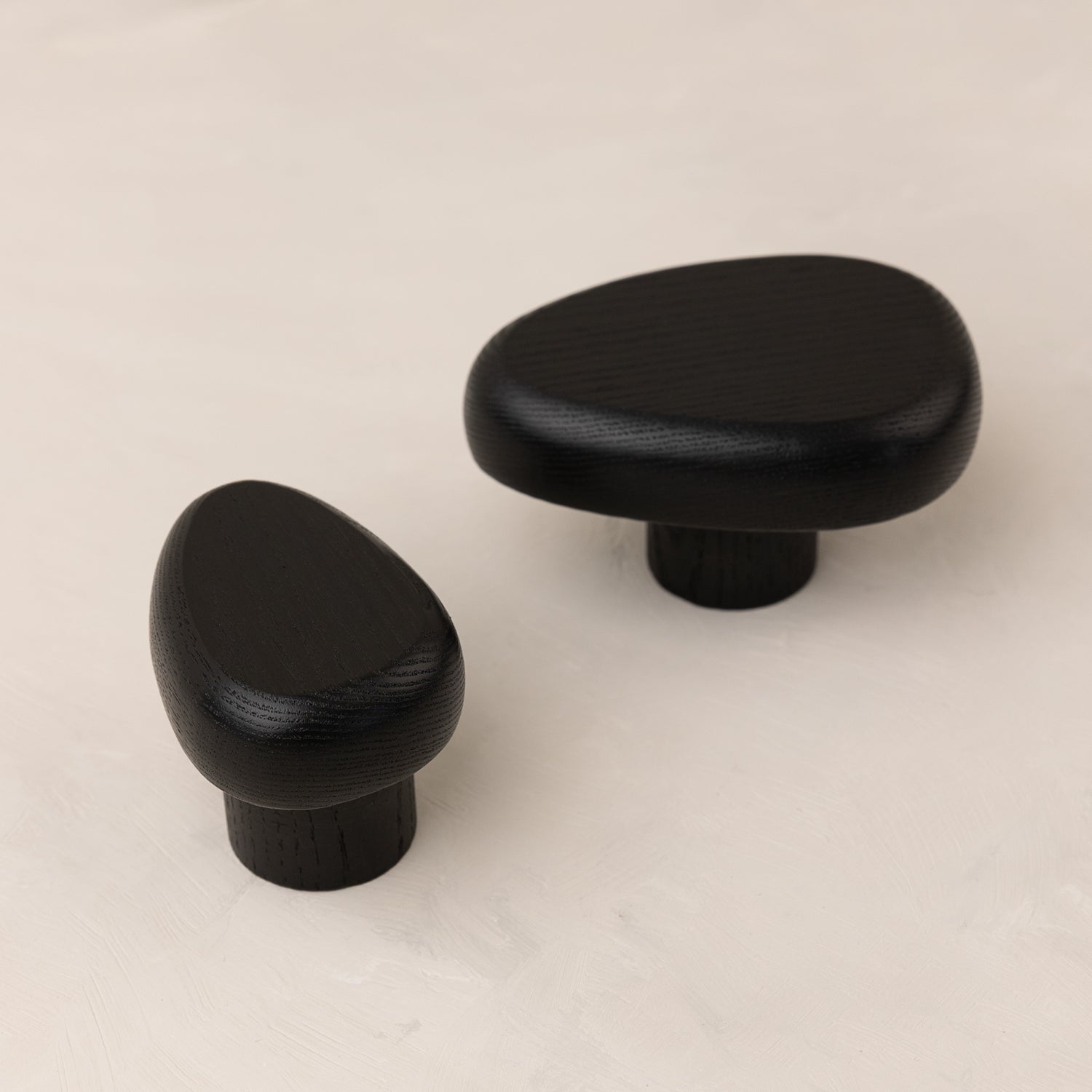 Black wall hook DROP by Biotite for organization, featuring a sleek, modern design mounted on a wall.