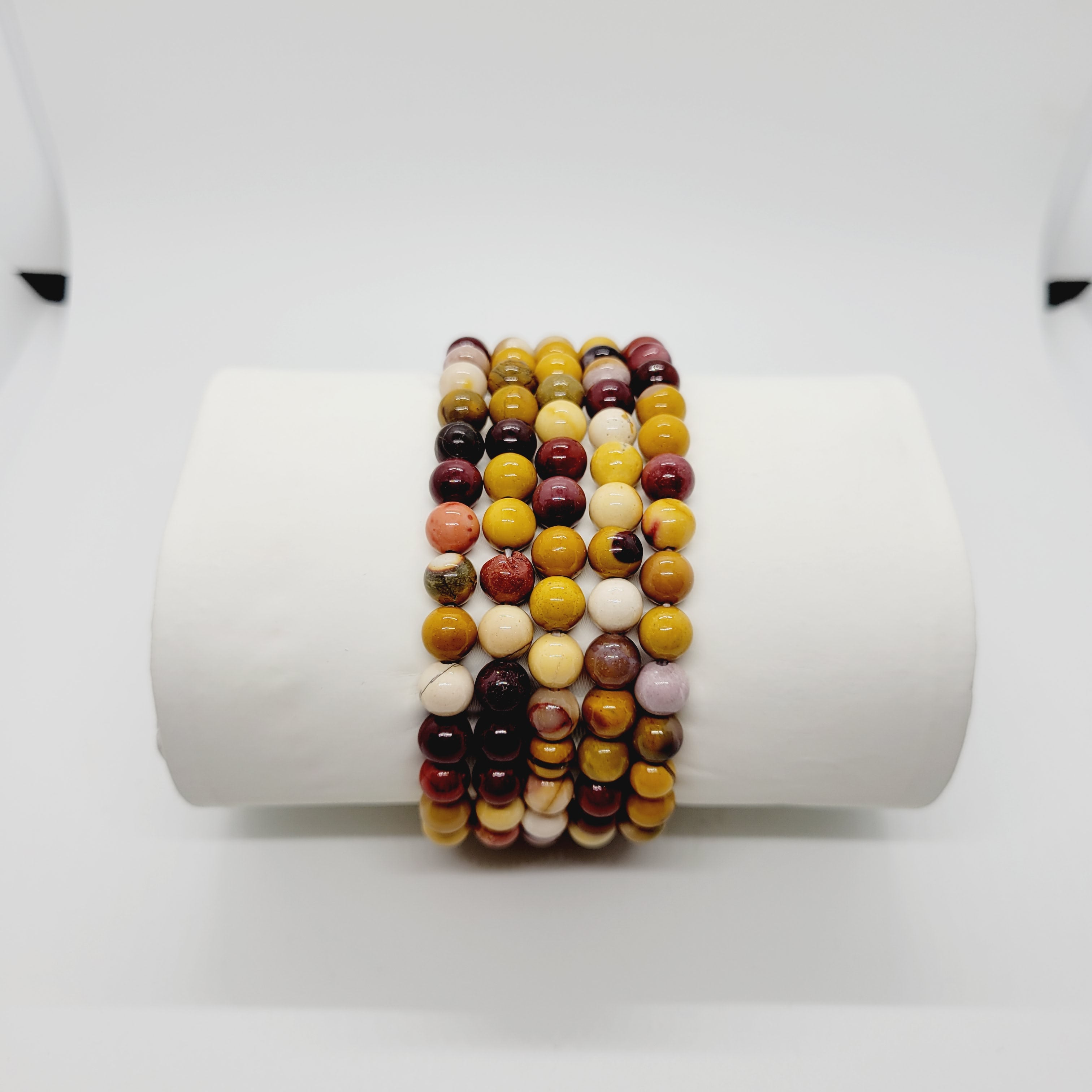 Olive Coeus Mookite stone bracelets featuring metaphysical and Reiki healing elements, boho style with natural earthy tones.