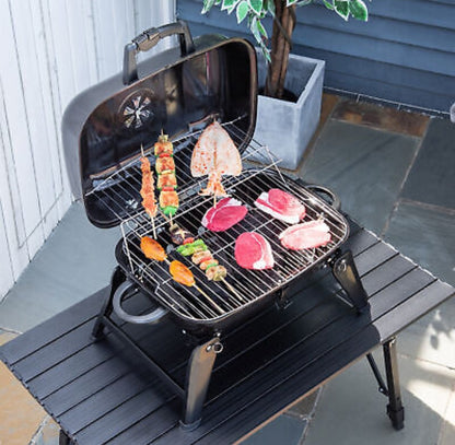 Yellow Pandora portable tabletop charcoal grill for kitchen use, compact design with grilling surface and vented lid.